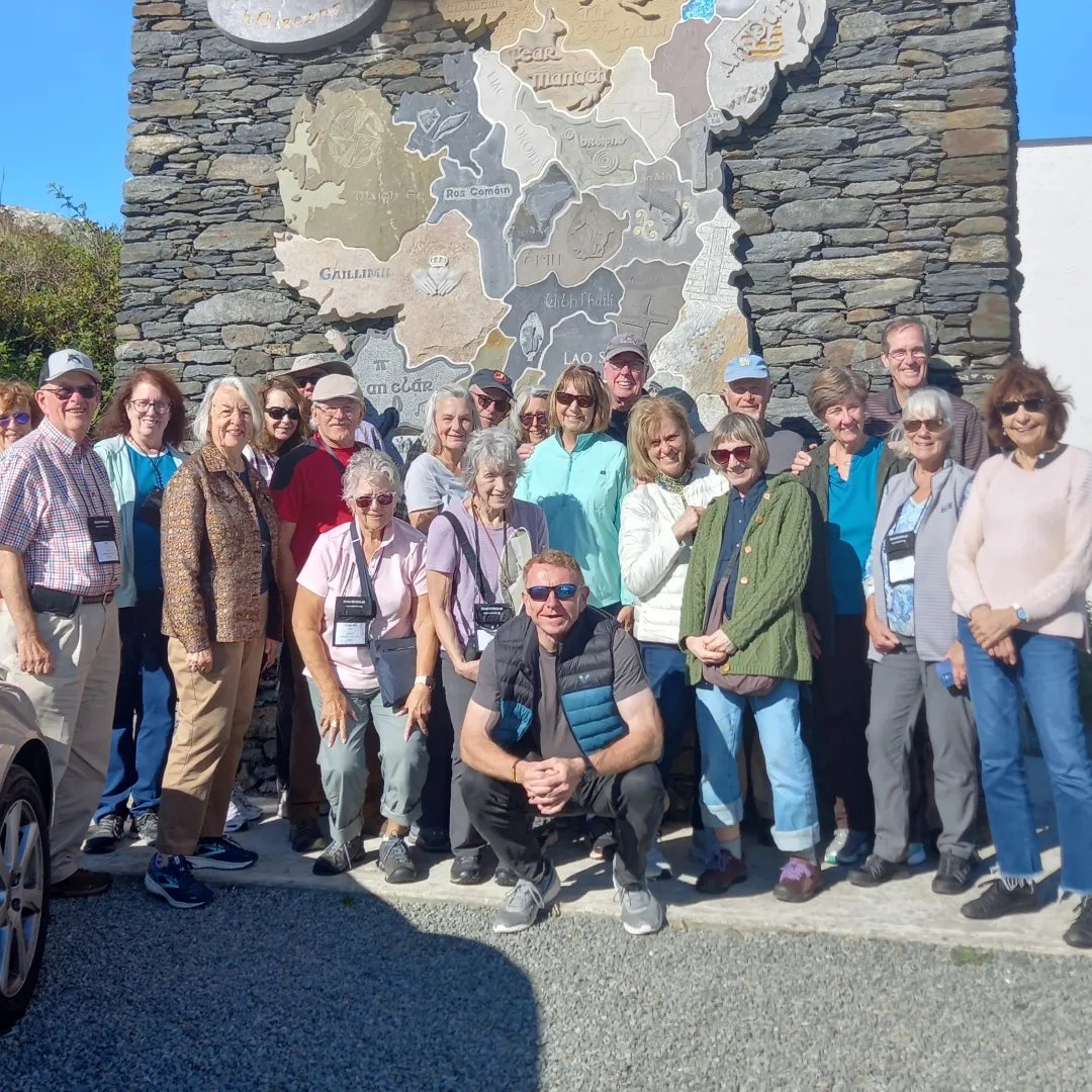 group of people standing in front of ireland sign 