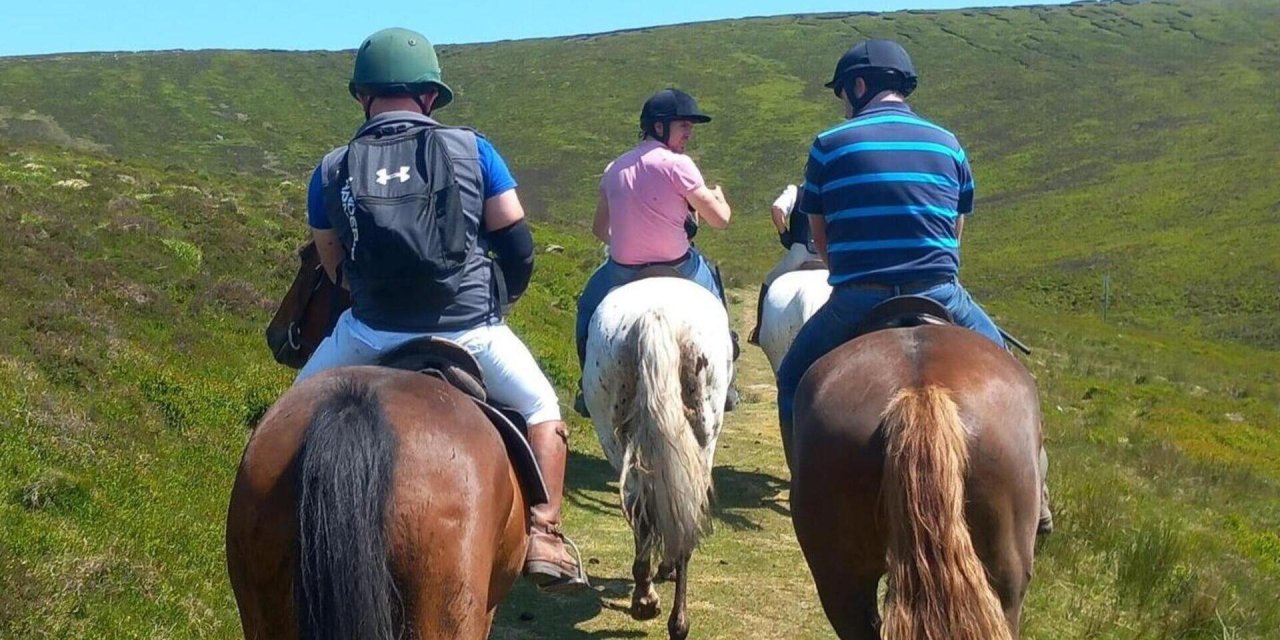 three people on horses